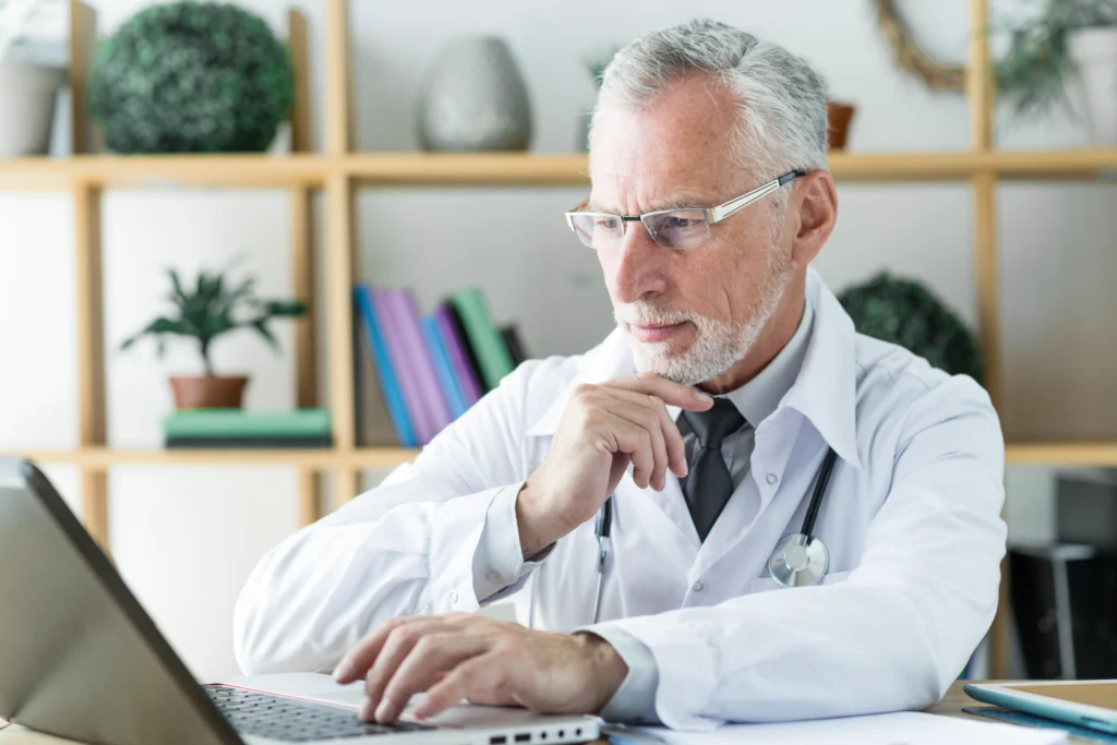 A doctor reviewing medical documents, ensuring accurate patient care and treatment planning.