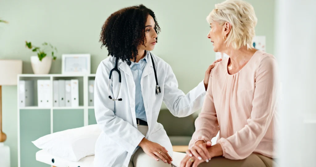 A doctor talking to a patient during a check-up visit, ensuring compassionate and attentive care.