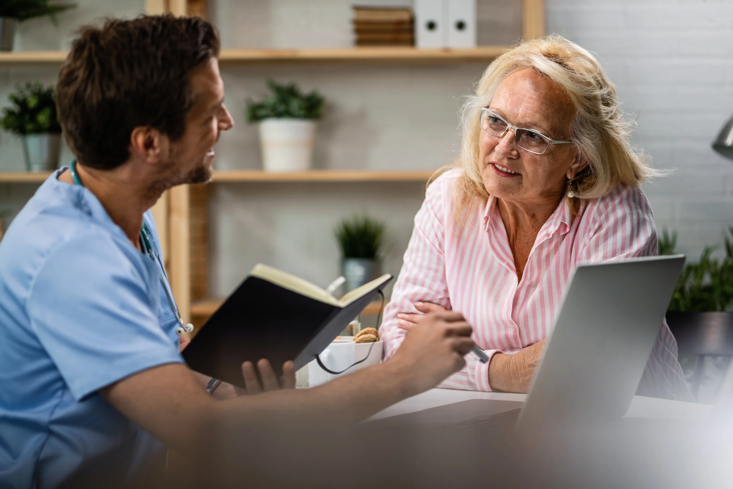 A senior woman consulting with a medical professional, discussing healthcare options.